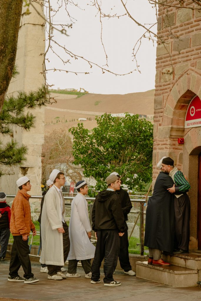 People entering a mosque in Ankara, Türkiye, capturing a traditional and cultural moment outdoors.