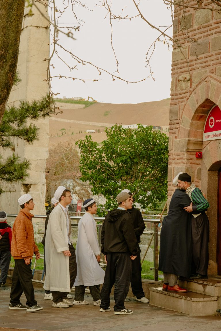 People entering a mosque in Ankara, Türkiye, capturing a traditional and cultural moment outdoors.